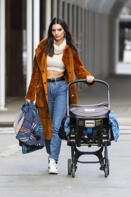 American model Emily Ratajkowski steps out to Sunday lunch at Odeon in New York City on January 23, 2022. The 30 year old American model looked stylist in a cream colored midriff bearing crop trop under a bight orange coat paired with denim trousers and white trainers. (Photo by The Image Direct)
