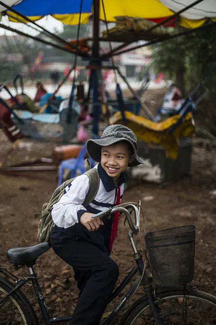 “A friendly country”. Vietnamese boy riding his bike right after school. Photo location: Hanoi. (Photo and caption by Mauricio Corridan/National Geographic Photo Contest)