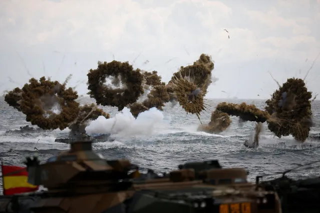 Amphibious assault vehicles of the South Korean Marine Corps fire smoke bombs as they move to land on the shore during a U.S.-South Korea joint landing operation drill as a part of the two countries' annual military training called Foal Eagle, in Pohang, South Korea, April 2, 2017. (Photo by Kim Hong-Ji/Reuters)