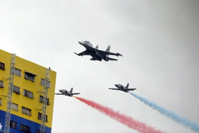 Airplanes from the Venezuelan Air Force take part in a military parade to celebrate the anniversary of Venezuela's independence in Caracas, July 5, 2015. (Photo by Jorge Dan Lopez/Reuters)