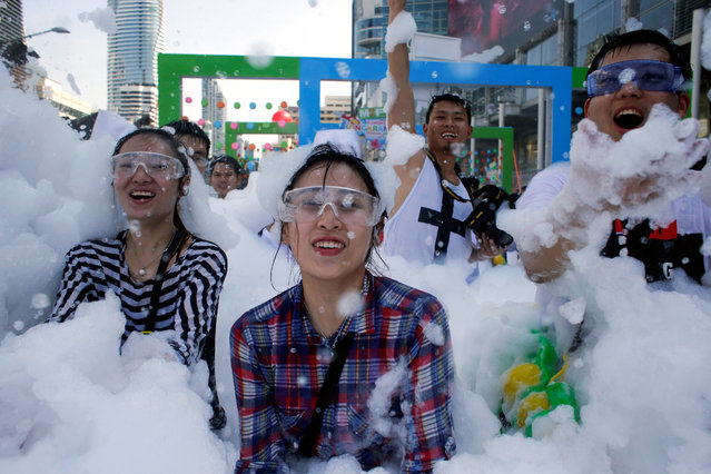 Revellers react at a foam party during Songkran Festival celebrations in Bangkok, Thailand on April 13, 2017. (Photo by Jorge Silva/Reuters)