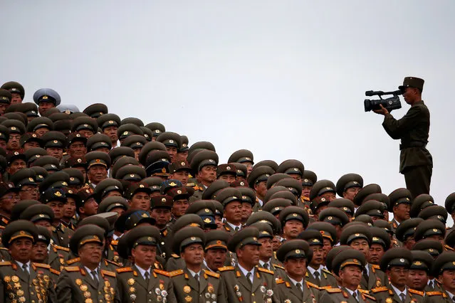 A solider films military officers following a mass dance performance in the capital's main ceremonial square, a day after the ruling Workers' Party of Korea party wrapped up its first congress in 36 years, in Pyongyang, North Korea, May 10, 2016. (Photo by Damir Sagolj/Reuters)