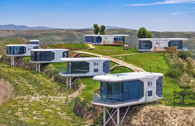 Tourists play at the “space capsule camp” in Ganjing village, Guyuan city, Northwest China's Ningxia Hui Autonomous region, June 23, 2024. (Photo by CFOTO/Future Publishing via Getty Images)