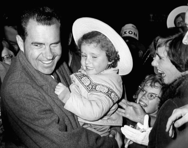 Vice President Richard M. Nixon is shown carrying an unidentified child at Pennsylvania Station in Pittsburgh, PA on October 24, 1960. (Photo by AP Photo)