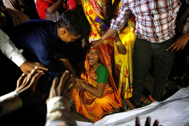 Relatives mourn the death of stampede victims Kamlesh Jatav, 22, and her seven-month-old daughter in Daunkeli village, Hathras district, in the northern state of Uttar Pradesh, India on July 3, 2024. (Photo by Anushree Fadnavis/Reuters)