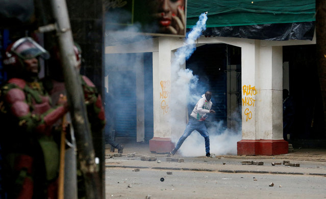 A protester throws a teargas can during an anti-government demonstration following nationwide deadly riots over tax hikes and a controversial now-withdrawn finance bill, in Nairobi, Kenya on July 16, 2024. (Photo by Thomas Mukoya/Reuters)