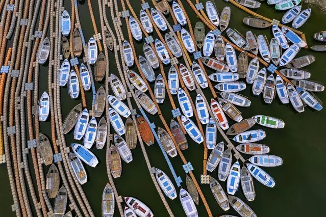 Boats stand parked on the Yamuna in Prayagraj, India, Monday, March 28, 2022. The river is considered sacred by Hindus. (Photo by Rajesh Kumar Singh/AP Photo)
