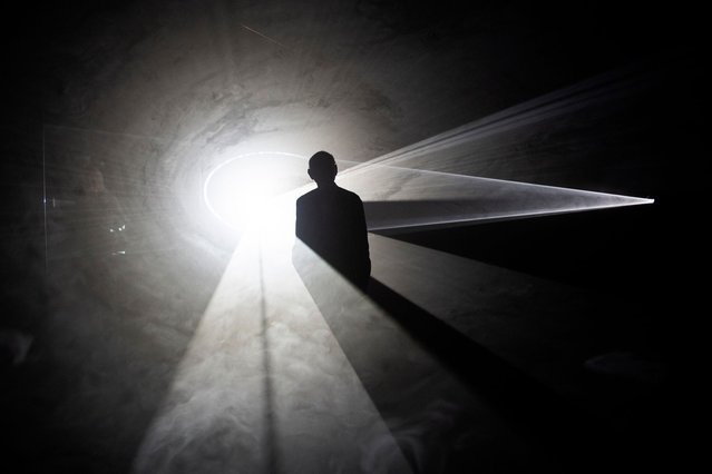 Picture shows the silouhette of British artist Anthony McCall in the artwork “Split Second (Mirror) IV, 2024” , during the presentation of the art exhibition “Split Second” at the Guggenheim Bilbao Museum in the Spanish Basque city of Bilbao on June 19, 2024. (Photo by Ander Gillenea/AFP Photo)