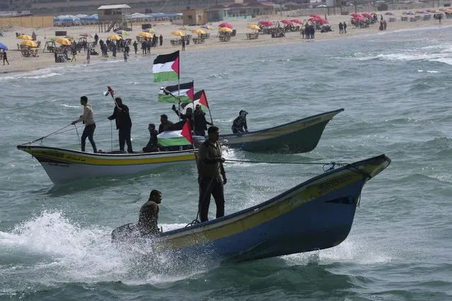 Palestinian fishermen ride their boats while wave their national flags during a rally marking the 46st anniversary of Land Day, in the water of the Mediterranean Sea at the fishermen port in Gaza City, Wednesday, March 30, 2022. Palestinians citizens of Israel and in the West Bank and Gaza mark “Land Day” on March 30, commemorating events in March 1976 when Israel confiscated land from Galilee Arab villages, leading to protests in which six Arabs were killed. The “Land Day” rallies are an annual event attended by those who protest what they say are discriminatory Israeli land policies. (Photo by Adel Hana/AP Photo)