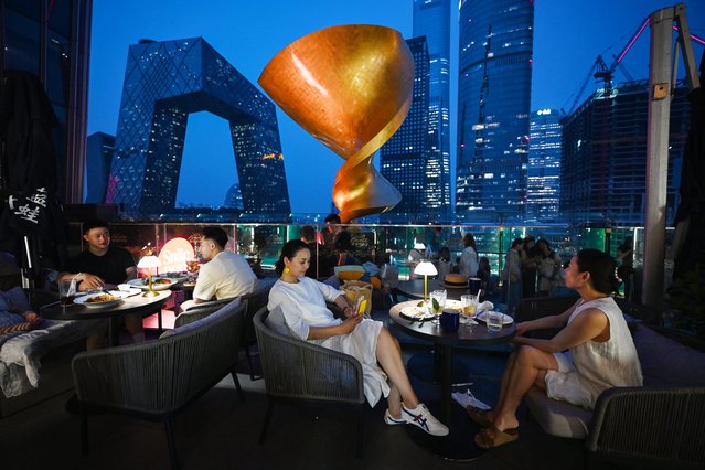 People eat in a restaurant in Beijing’s central business district on July 11, 2024. Eyes are turning to the start of China's Third Plenum gathering on July 15, where top officials including President Xi Jinping are expected to discuss ways to kickstart the world's number two economy in the face of an ongoing property crisis and geopolitical issues. (Photo by Greg Baker/AFP Photo)