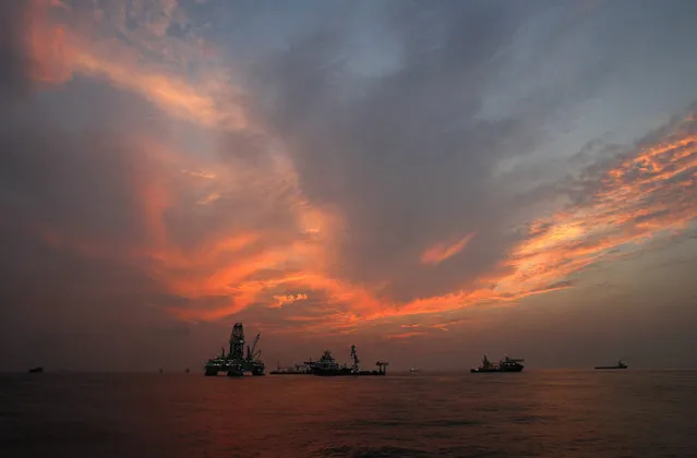 This Saturday, September 4, 2010 file photo shows vessels assisting in the drilling of the Deepwater Horizon relief well on the Gulf of Mexico near the coast of Louisiana at sunset. (Photo by Patrick Semansky/AP Photo)