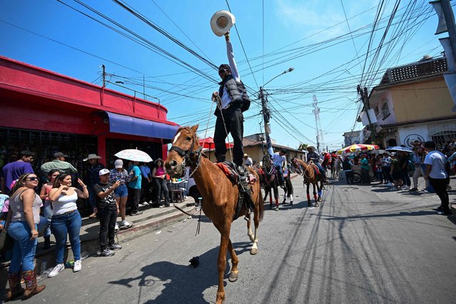 Horse riders participate in the traditional horse parade through the main streets of Amatitlan, south of Guatemala City, on May 7, 2023, to celebrate the Day of the Cross. (Photo by Johan Ordonez/AFP Photo)