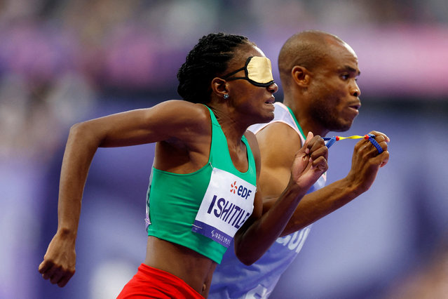 Lahja Ishitile of Namibia with guide Sem Shimanda in action during the women's 400m T11 final in Saint-Denis, France on August 31, 2024. (Photo by Stephanie Lecocq/Reuters)