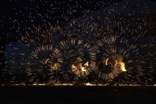 Performers during a fire spectacle to celebrate Mid Autumn Festival in Beijing, China, 15 September 2024. The Mid-Autumn Festival, also known as the Mooncake Festival, is celebrated on the 15th of the eighth lunar month. (Photo by Andres Martinez Casares/EPA/EFE)