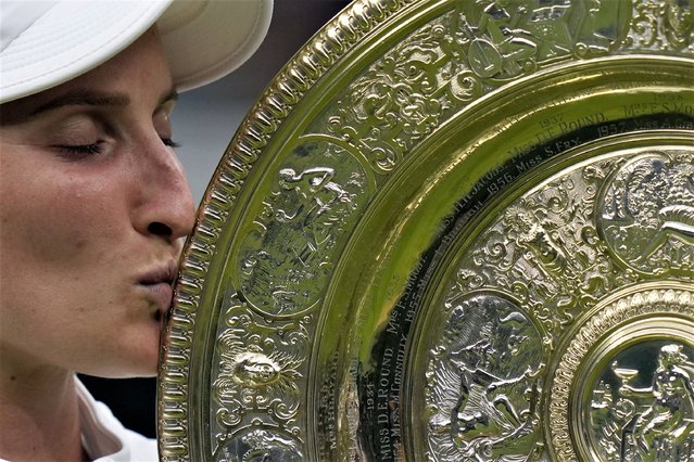 Czech Republic's Marketa Vondrousova celebrates with the trophy after beating Tunisia's Ons Jabeur in the women's singles final on day thirteen of the Wimbledon tennis championships in London, Saturday, July 15, 2023. (Photo by Alastair Grant/AP Photo)