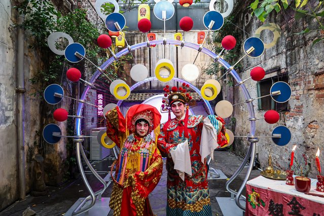 Jean, 72, (L) and Joyce, 64, (R) perform Chinese Opera in front of a crowd at Kwai Chai Hong, a heritage revival back alley in Chinatown on August 15, 2024 in Kuala Lumpur, Malaysia. Kwai Chai Hong celebrates the Mid-Autumn Festival by bringing the grandeur of Chinese Opera to life with the “Drama Queen” art installation, created in collaboration with local artist Tan Sher Lynn, blending cultural heritage with modern creativity to revitalize Downtown Kuala Lumpur's historic core, drawing inspiration from the historical art form of Chinese Opera and juxtaposing ancient art with modern flair to engage younger generations. (Photo by Annice Lyn/Getty Images)