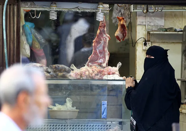 A woman buys meat as she shops during the holy fasting month of Ramadan at Bab Makkah old market in Jeddah, Saudi Arabia, June 7, 2016. (Photo by Faisal Al Nasser/Reuters)
