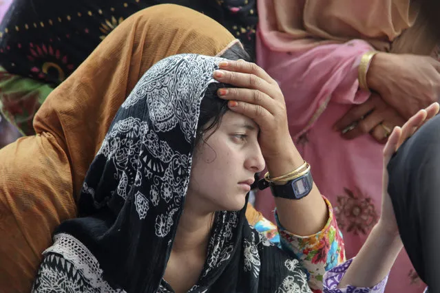 Daughter of Indian civilian Sarpanch Karamat Hussain who was killed in Pakistani shelling mourns at Balakot sector in Poonch, Jammu and Kashmir, India, Sunday, August 16, 2015. Indian and Pakistani troops traded heavy gunfire and mortar rounds for a seventh day Sunday along the highly militarized line of control dividing the disputed Himalayan region of Kashmir between the two archrivals, officials said. (Photo by Channi Anand/AP Photo)