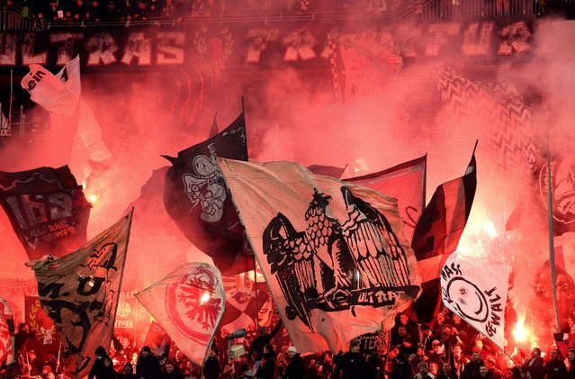 Fans of Eintracht Frankfurt show their support as they light flares and wave flags prior to kick-off ahead of the UEFA Europa League 2024/25 League Phase MD4 match between Eintracht Frankfurt and SK Slavia Praha at Frankfurt Stadion on November 07, 2024 in Frankfurt am Main, Germany. (Photo by Alexander Hassenstein/Getty Images)