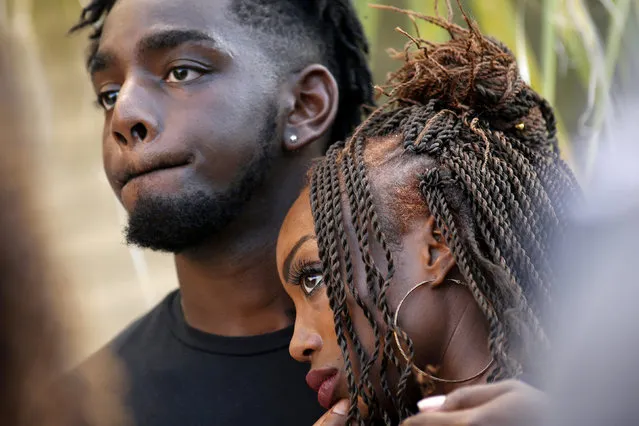 Jacob Rogers and Whitney Welch embrace during a vigil for Baton Rouge police officer Montrell Jackson, who was shot and killed Sunday morning, in Baton Rouge, Louisiana, U.S. July 19, 2016. Montreal Jackson provided detail security at Laser Tag of Baton Rouge where Welch worked. (Photo by Jonathan Bachman/Reuters)