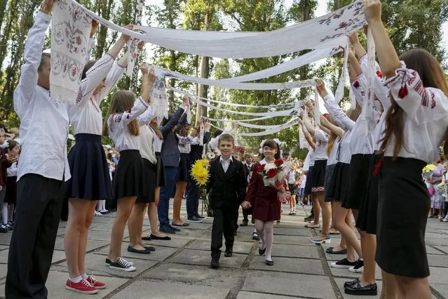 First graders take part in a ceremony to mark the start of another school year in Kiev, Ukraine, September 1, 2015. (Photo by Gleb Garanich/Reuters)
