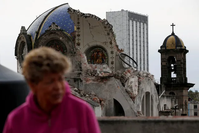 A person walks past the church dome of Our Lady of los Angeles, which collapsed six days after an earthquake, in Mexico City, Mexico September 24, 2017. (Photo by Carlos Jasso/Reuters)