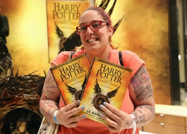 A woman holds copies of the book of the play of Harry Potter and the Cursed Child parts One and Two at a bookstore in London, Britain July 31, 2016. (Photo by Neil Hall/Reuters)
