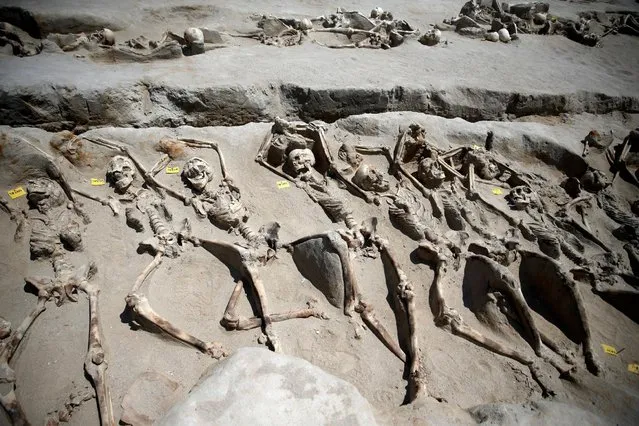 At least 80 skeletons have been discovered in an ancient Falyron Delta cemetery which dates back to between 5th-8th century BC, in Athens, Greece, July 27, 2016. With their wrists clamped in iron shackles, archeologists believe that these are the remains of victims who died in a mass execution. However, who they were and how they got there is unknown. (Photo by Alkis Konstantinidis/Reuters)