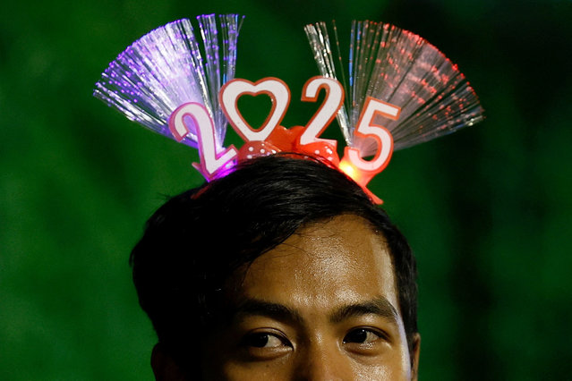 A man wearing a 2025 headband attends New Year's Eve celebrations in Jakarta, Indonesia, on December 31, 2024. (Photo by Willy Kurniawan/Reuters)