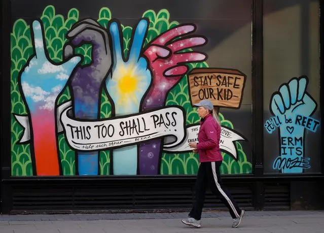 A woman runs past a mural in Manchester, following the outbreak of the coronavirus disease (COVID-19), Manchester, Britain, May 4, 2020. (Photo by Phil Noble/Reuters)