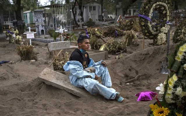 A worker in charge of burying people who lost their lives due to COVID takes a break at San Lorenzo Tezonco Cemetery on May 15, 2020 in Mexico City, Mexico. Mexico is facing the peak of COVID-19 contagion according to Hugo Lopez-Gatell Undersecretary of Prevention and Health Promotion. Mexico City remains the State with the higher number of cases and deceases. (Photo by Cristopher Rogel Blanquet/Getty Images)