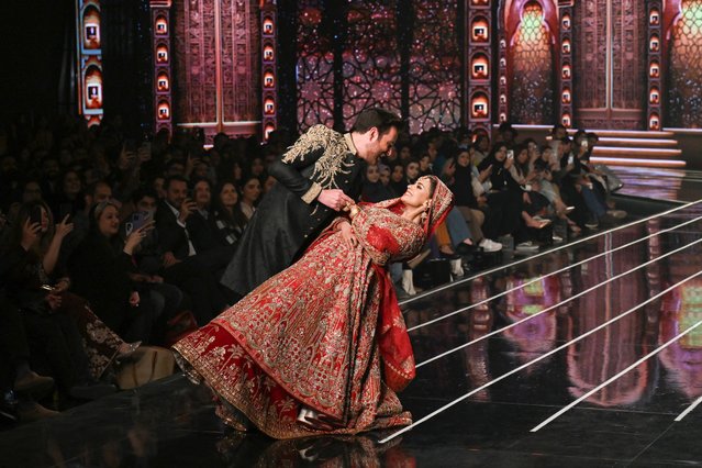 Models present creations by fashion designer Basit Sipra during the Neo HUM Bridal Couture Week, in Lahore, on December 21, 2024. (Photo by Arif Ali/AFP Photo)