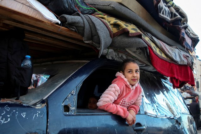 A Palestinian girl looks out of a vehicle as she waits other people to be allowed to return to their homes in northern Gaza after they were displaced to the south at Israel's order during the war, amid a ceasefire between Israel and Hamas, in the central Gaza Strip on January 26, 2025. (Photo by Hatem Khaled/Reuters)