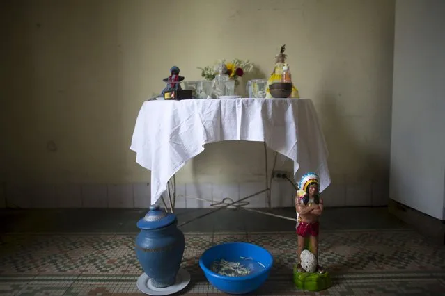 An altar produced for a ceremony of the Afro-Cuban religion Santeria to attract spirits of dead ancestors to ask for guidance is seen in a house in downtown Havana, August 18, 2015. (Photo by Alexandre Meneghini/Reuters)