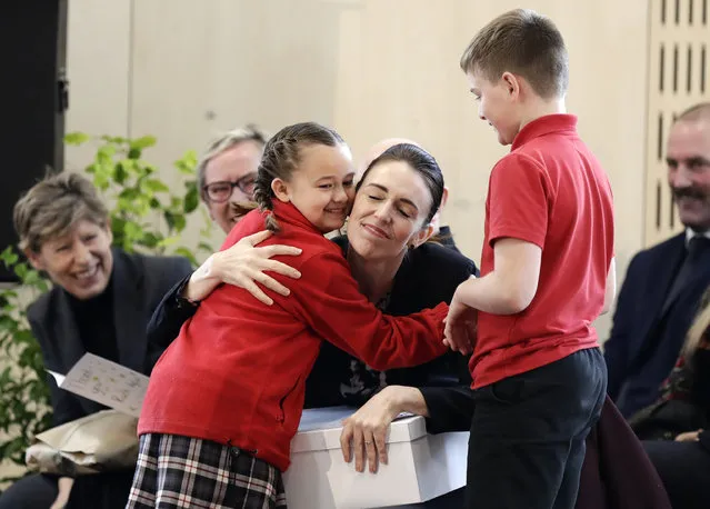 New Zealand Prime Minister Jacinda Ardern embraces a pupil during the opening ceremony for Redcliffs School in Christchurch, New Zealand, Thursday, June 25, 2020. The school was rebuilt following earthquakes almost nine years to the day forced pupils and staff from the site. (Photo by Mark Baker/AP Photo)