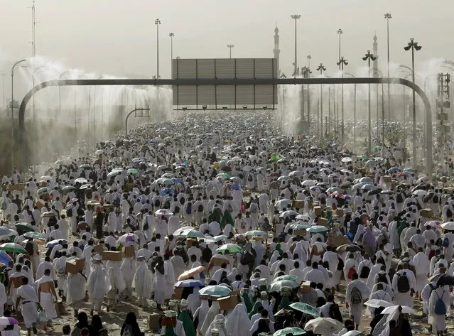 Muslim pilgrims pray on Mount Mercy on the plains of Arafat during the annual haj pilgrimage, outside the holy city of Mecca September 23, 2015. (Photo by Ahmad Masood/Reuters)