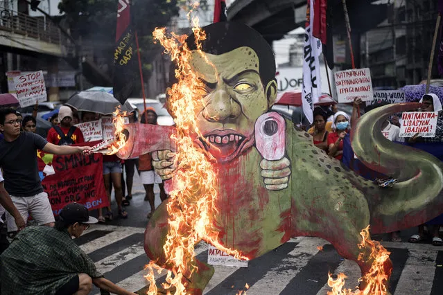 Activists burn a caricature of Philippine President Rodrigo Duterte as a gun- toting tyrannosaurus dinosaur in Mendiola, near the Malacanang palace in Manila on December 8, 2017. The demonstrators denounced the government' s war on drugs campaign, the extension of martial law in Mindanao and the crackdown on activists, while calling for Duterte' s ouster from office. Philippine President Rodrigo Duterte on December 5 told human rights groups criticising his deadly anti- drug war to “go to hell” after ordering police back to the frontlines of the crackdown. (Photo by Noel Celis/AFP Photo)