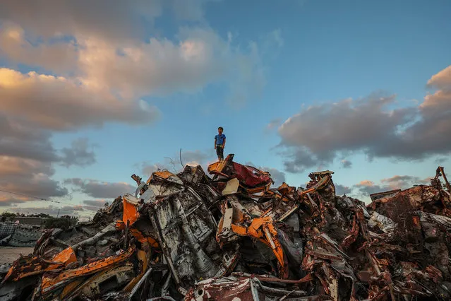 A Palestinian refugee boy stands at the destroyed cars near his family house in Khan Younis refugee camp in the southern Gaza St​rip, 24 June 2020. (Photo by Mohammed Saber/EPA/EFE)