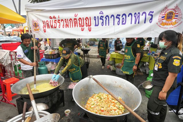 Volunteers prepare supper for rescuers and relatives waiting at the site of an under-construction high-rise building that collapsed after an earthquake in Bangkok, Thailand, Monday, March, 31, 2025. (Photo by Manish Swarup/AP Photo)