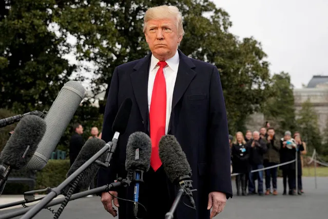 U.S. President Donald Trump listens to question from the media on South Lawn of the White House in Washington, U.S., before his departure to visit the FBI Academy in Quantico, Virginia, U.S. December 15, 2017. (Photo by Yuri Gripas/Reuters)