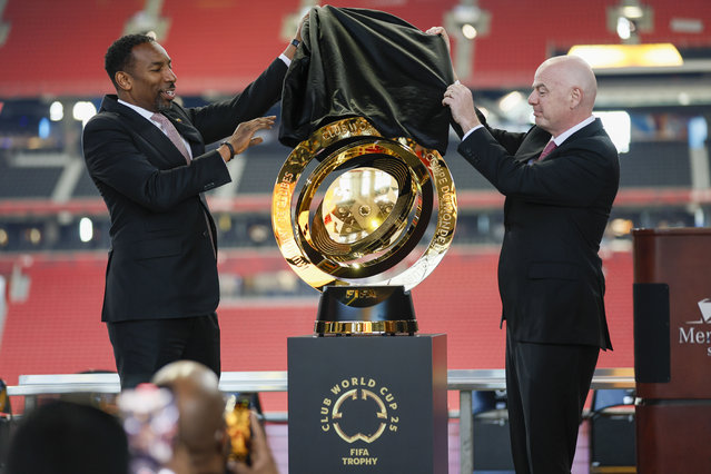 Atlanta Mayor Andre Dickens, left, and FIFA President Gianni Infantino, right, unveil the FIFA Club World Cup soccer trophy during a news conference at Mercedes-Benz Stadium, Monday, April 14, 2025, to discuss the upcoming 2025 Club World Cup which is to be be hosted by Atlanta this summer. (Photo by Miguel Martinez/Atlanta Journal-Constitution via AP Photo)