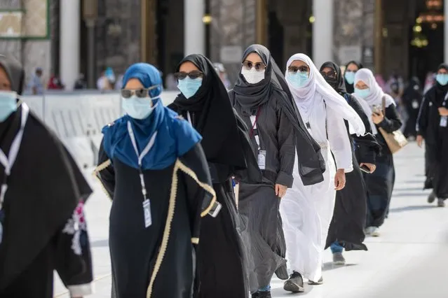 Muslim pilgrims wearing protective face masks arrive to circle the Kaaba, July 29, 2020. For the first time in the modern era, amidst efforts to curb COVID-19, Muslims from abroad will be unable to attend the pilgrimage. This year's event has been limited to about 1,000 pilgrims from within Saudi Arabia, 70% of whom will be foreign residents of the kingdom. The remaining 30% will be drawn from Saudi healthcare workers and security personnel who have recovered from the coronavirus, as a gesture of thanks for their sacrifice. (Photo by Saudi Ministry of Media/Handout via Reuters)