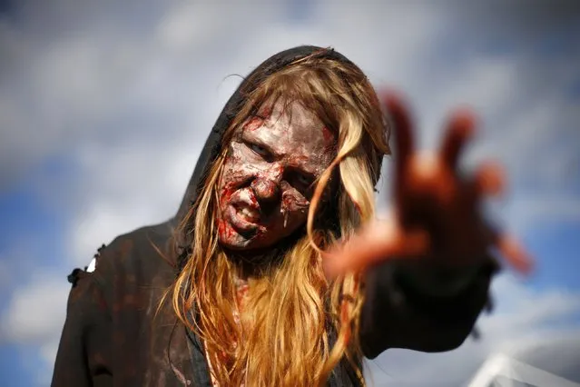 Marie, dressed as a zombie, poses outside the MCM Comicon at the Excel Centre in East London, October 25, 2014. (Photo by Andrew Winning/Reuters)