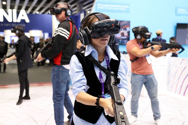 People play a video game with virtual reality headset, at the Mobile World Congress (MWC), in Barcelona, Spain on February 27, 2024. (Photo by Bruna Casas/Reuters)