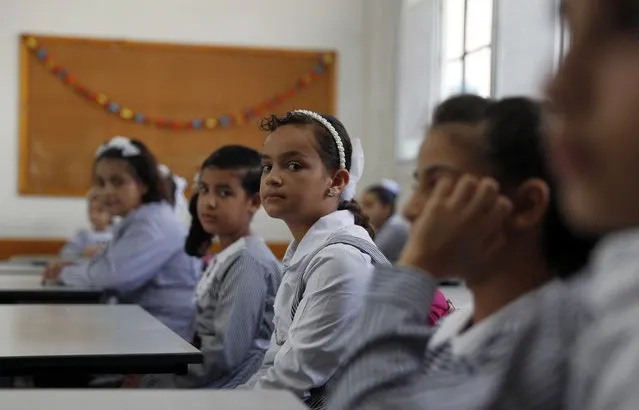 Students sit in their class on the first day of the new school year at the United-Nation run Elementary School at the Shati refugee camp in Gaza City, Saturday, August 8, 2020. Schools run by both Palestinian government and the U.N. Refugee and Works Agency (UNRWA) have opened almost normally in the Gaza Strip after five months in which no cases of community transmission of the coronavirus had been recorded. (Photo by Adel Hana/AP Photo)