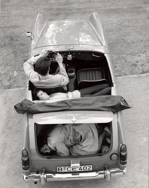 Heinz Meixner, with his fiancee and her mother Frau Thurau, show how they arranged themselves in his Austin-Healey Sprite to drive through the Berlin Wall in 1965. (Photo by Express Newspapers/Getty Images)