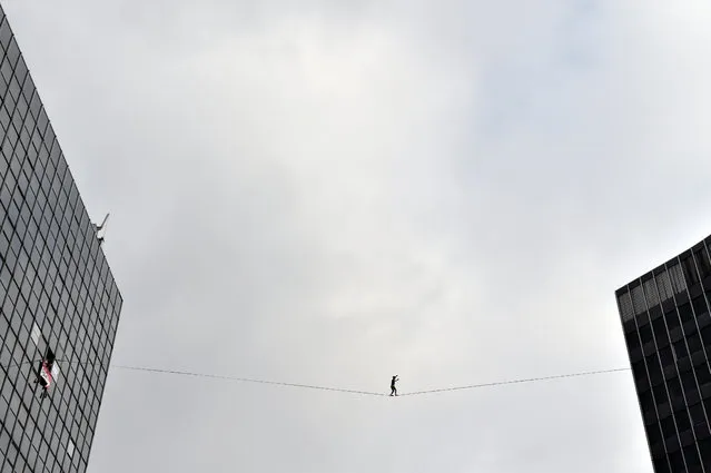 A tight rope walker performs on a line between two buildings in Brussels September 18, 2016. (Photo by Eric Vidal/Reuters)