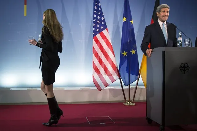 United States Secretary of State John Kerry smiles after a worker brought him water during a press briefing with Germany's Foreign Minister Frank-Walter Steinmeier in Berlin, Germany October 22, 2015. Kerry said talks with Israeli Prime Minister Benjamin Netanyahu on Thursday gave him a "cautious measure of optimism" that tensions between Israelis and Palestinians could be defused. (Photo by Carlo Allegri/Reuters)