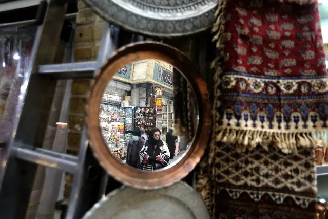 Iranians shop at the bazaar of Tajrish in northern Tehran on January 25, 2023. The EU and Britain slapped yesterday another round of sanctions on Iran, which has been rocked by protests since the September 16 death of Amini, a 22-year-old Iranian Kurd who had been arrested for allegedly breaching the country's strict dress code for women. The Islamic republic Iran vowed it will respond, warning of tit-for-tat measures. (Photo by Atta Kenare/AFP Photo)
