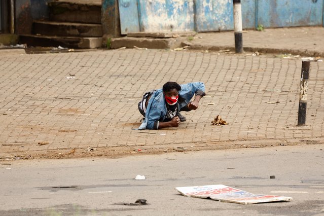 A demonstrator lies on the ground during clashes with riot police at the “Saba Saba People's March” anti-government protest in Nairobi, Kenya on July 7, 2025. (Photo by Thomas Mukoya/Reuters)